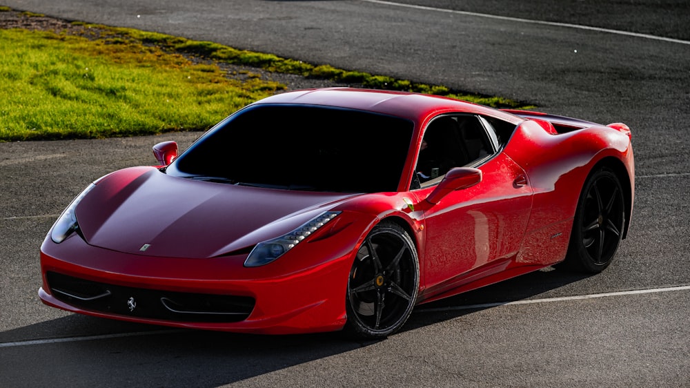 a red sports car driving on a race track