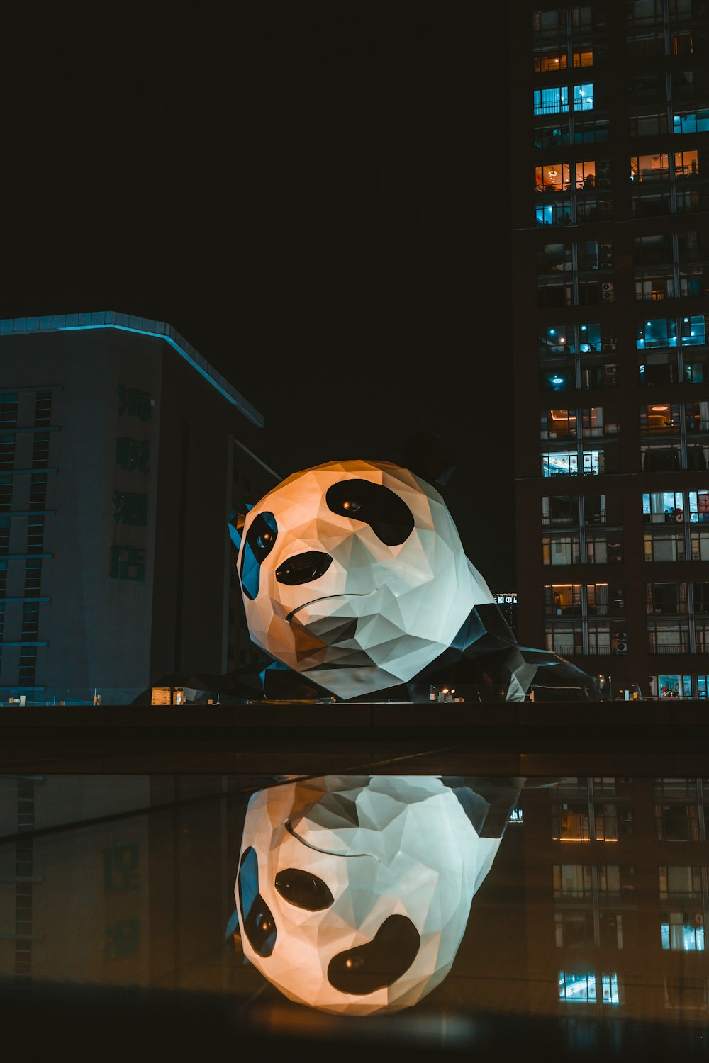 a large sculpture of a panda bear in front of a building