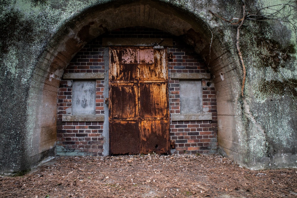 an old door in an old brick wall