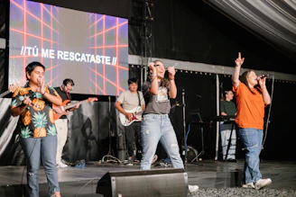 a group of people standing on top of a stage