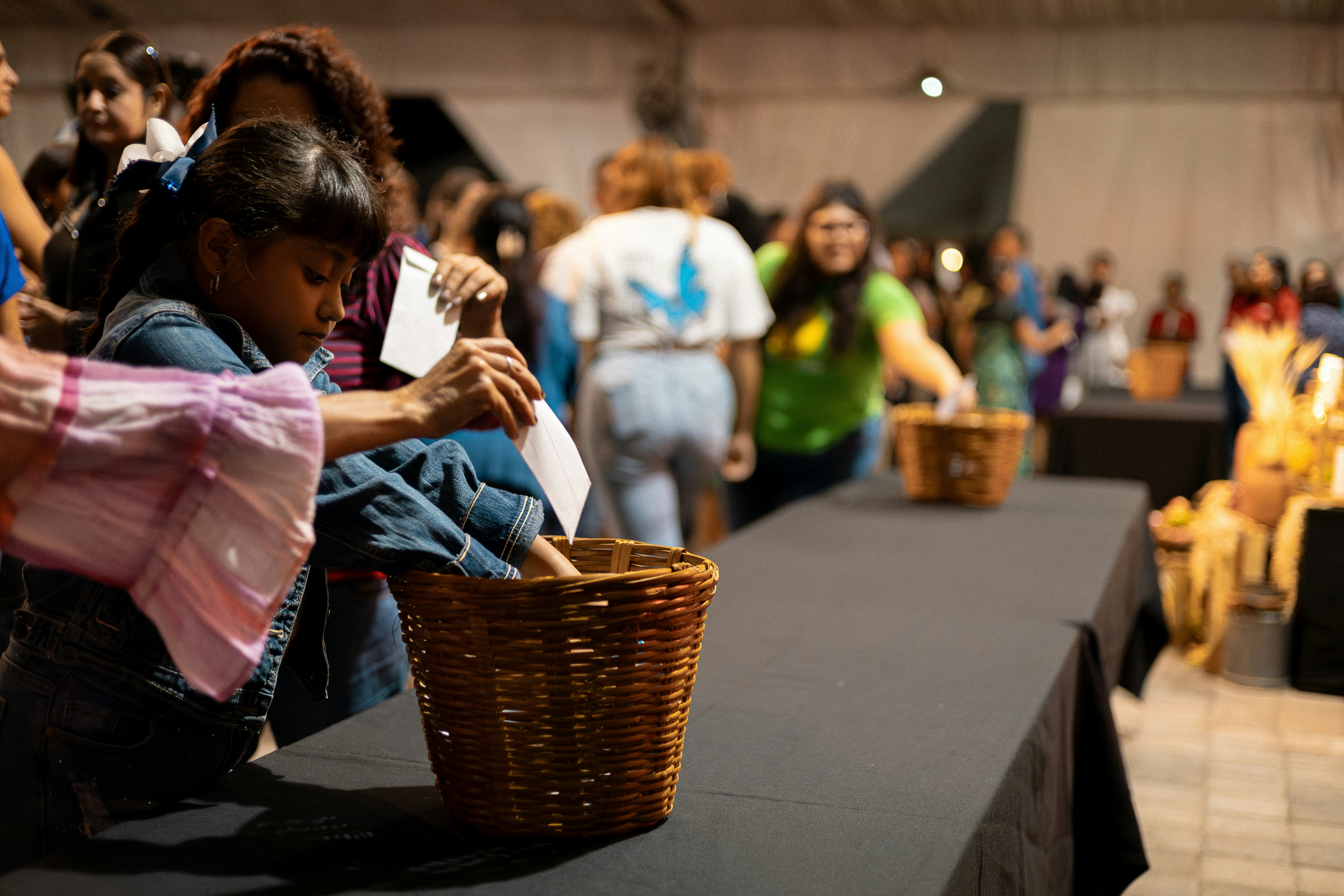 a group of people standing around a table