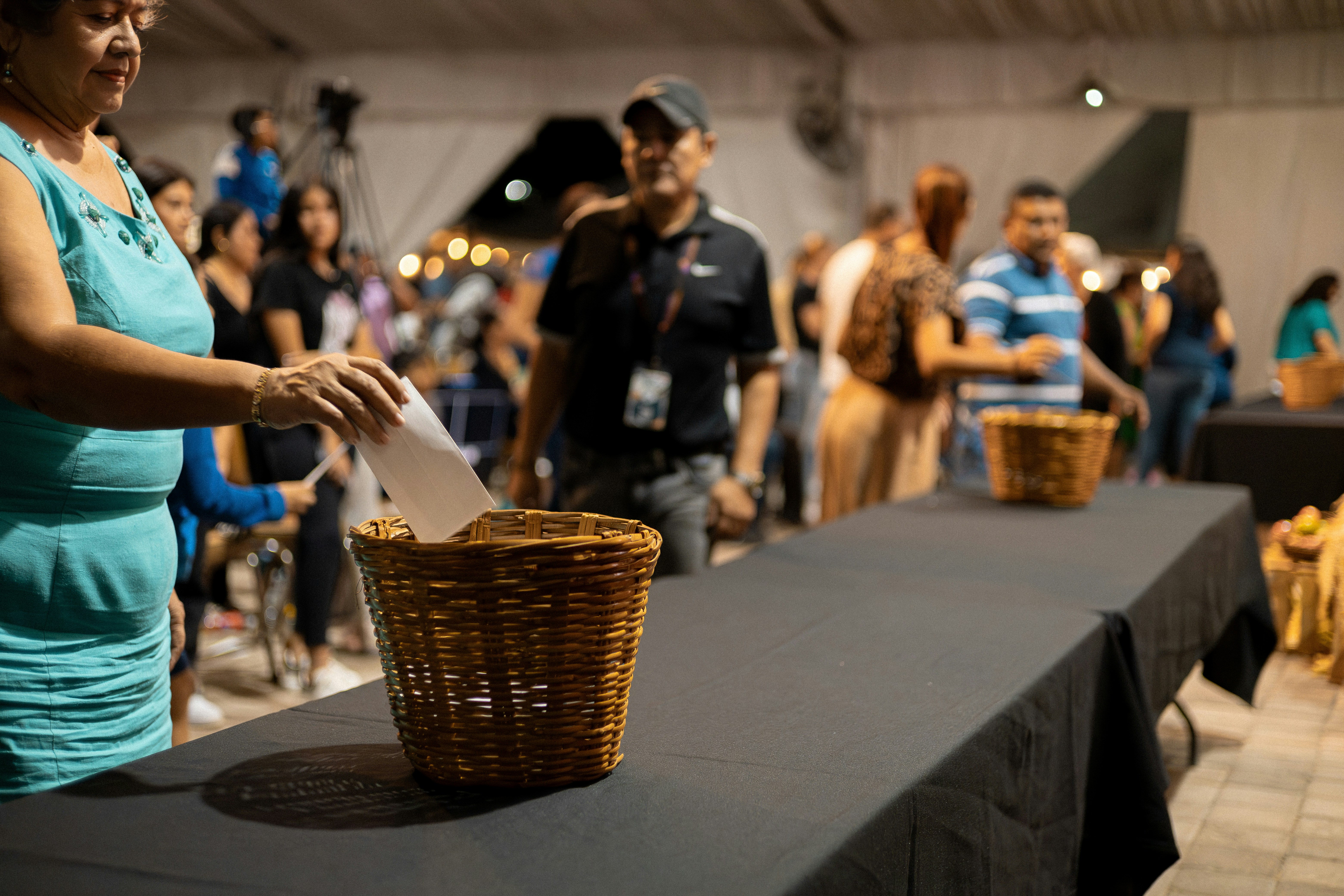 a group of people standing around a table