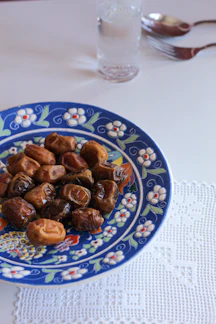 A plate of food on a table with a glass of water