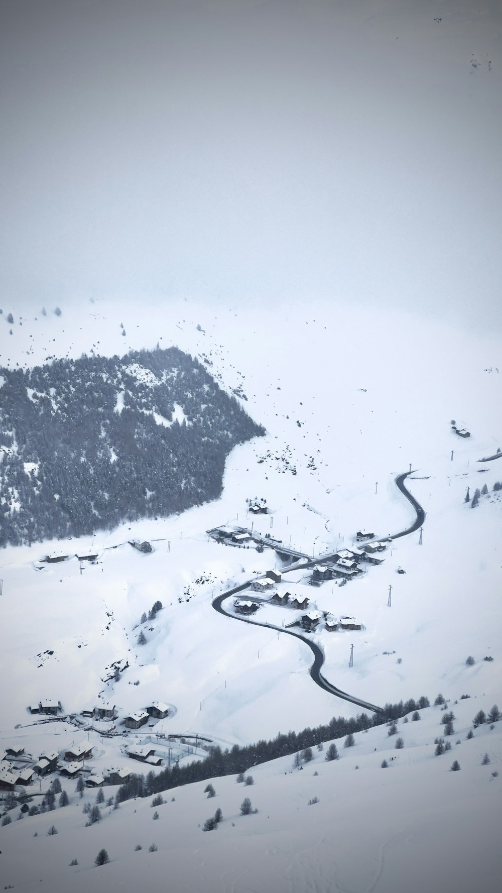 a snow covered mountain with a winding road