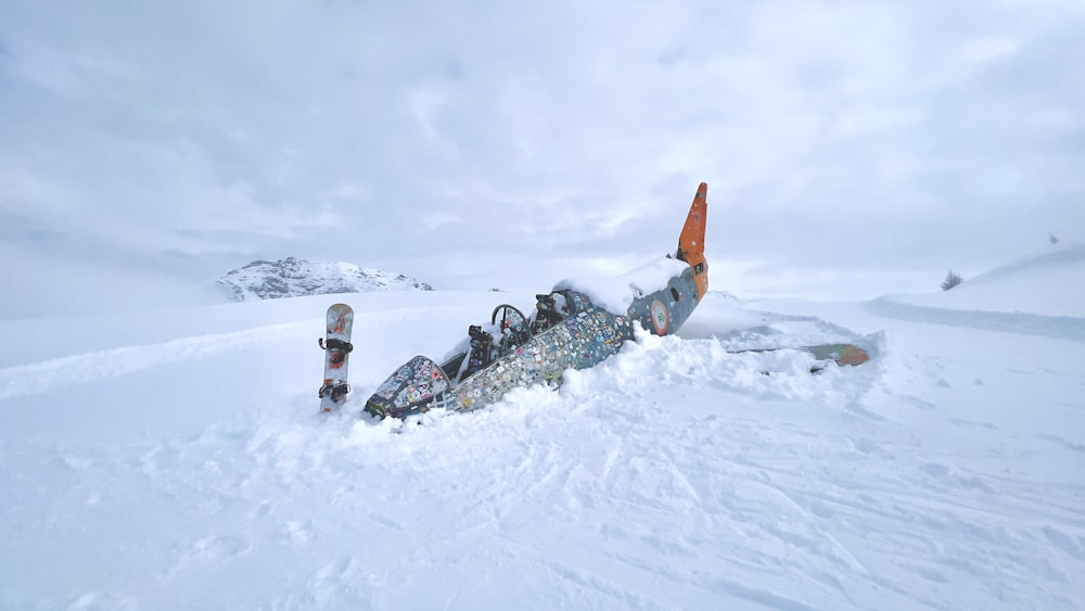 a person laying in the snow with a snowboard