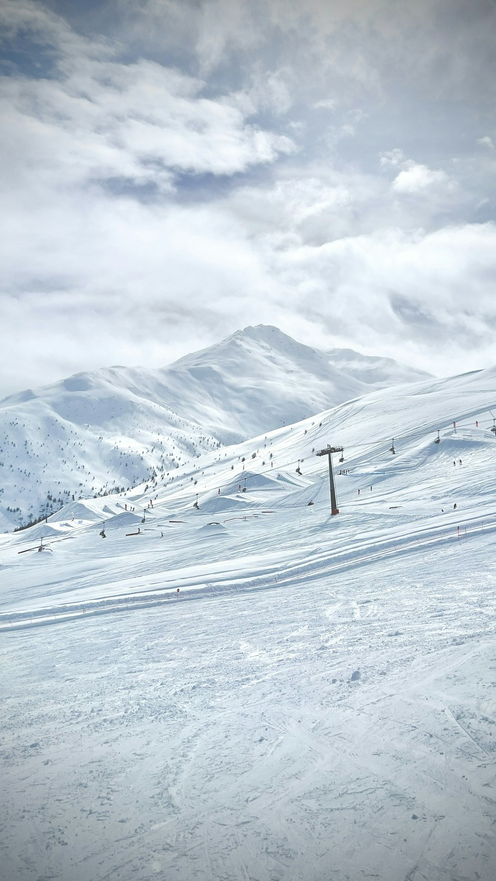 a man riding skis down a snow covered slope