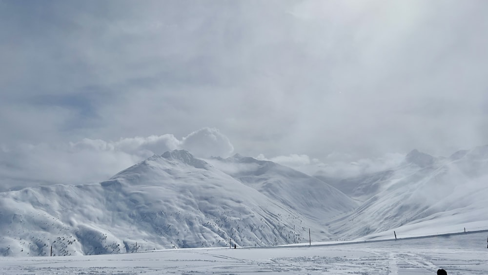 a group of people riding skis on top of a snow covered slope