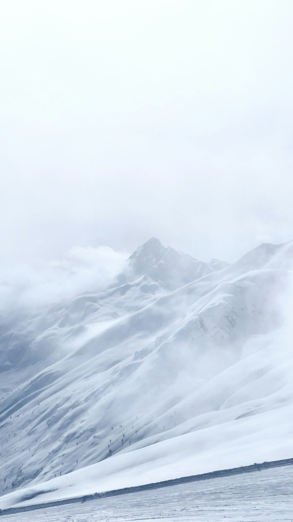 a man riding skis down a snow covered slope