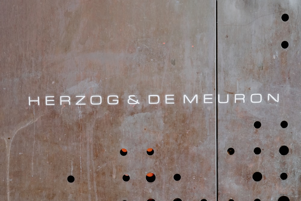 a close up of a metal door with holes