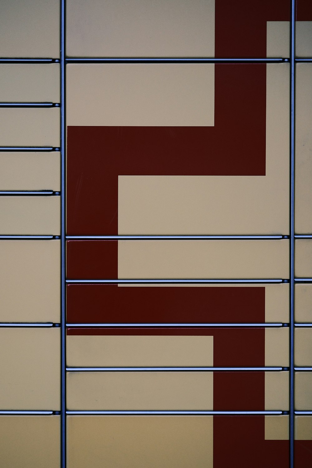 a close up of a metal fence with a red and white design on it