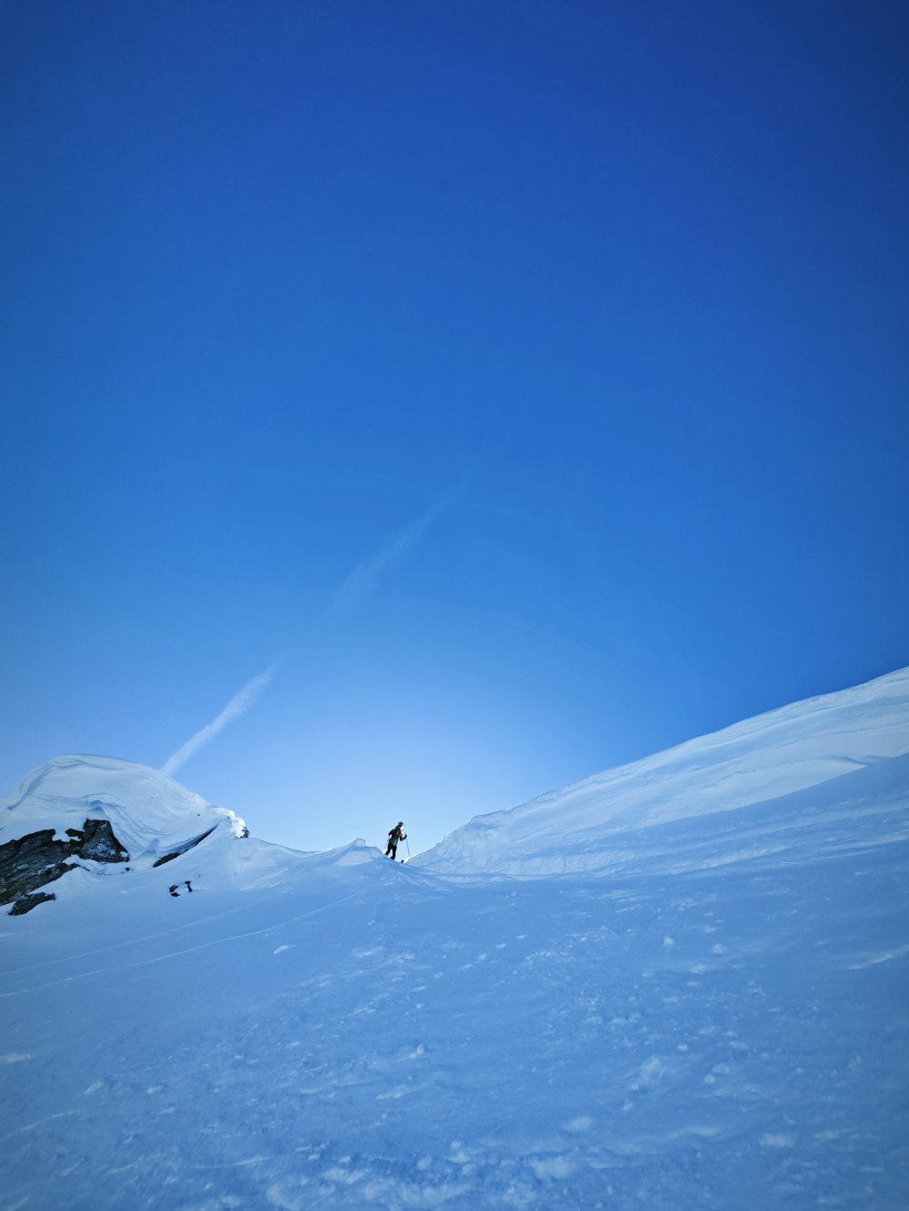a person is skiing down a snowy hill