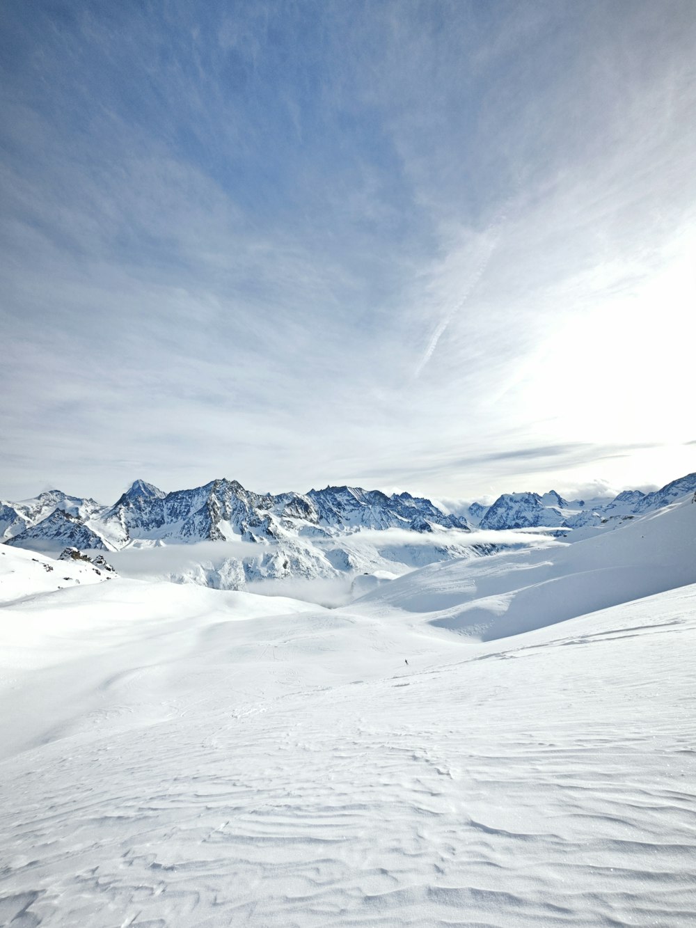 a person riding skis on top of a snow covered slope