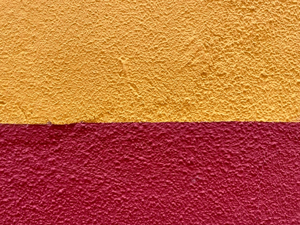 a red and yellow wall with a red and yellow stripe