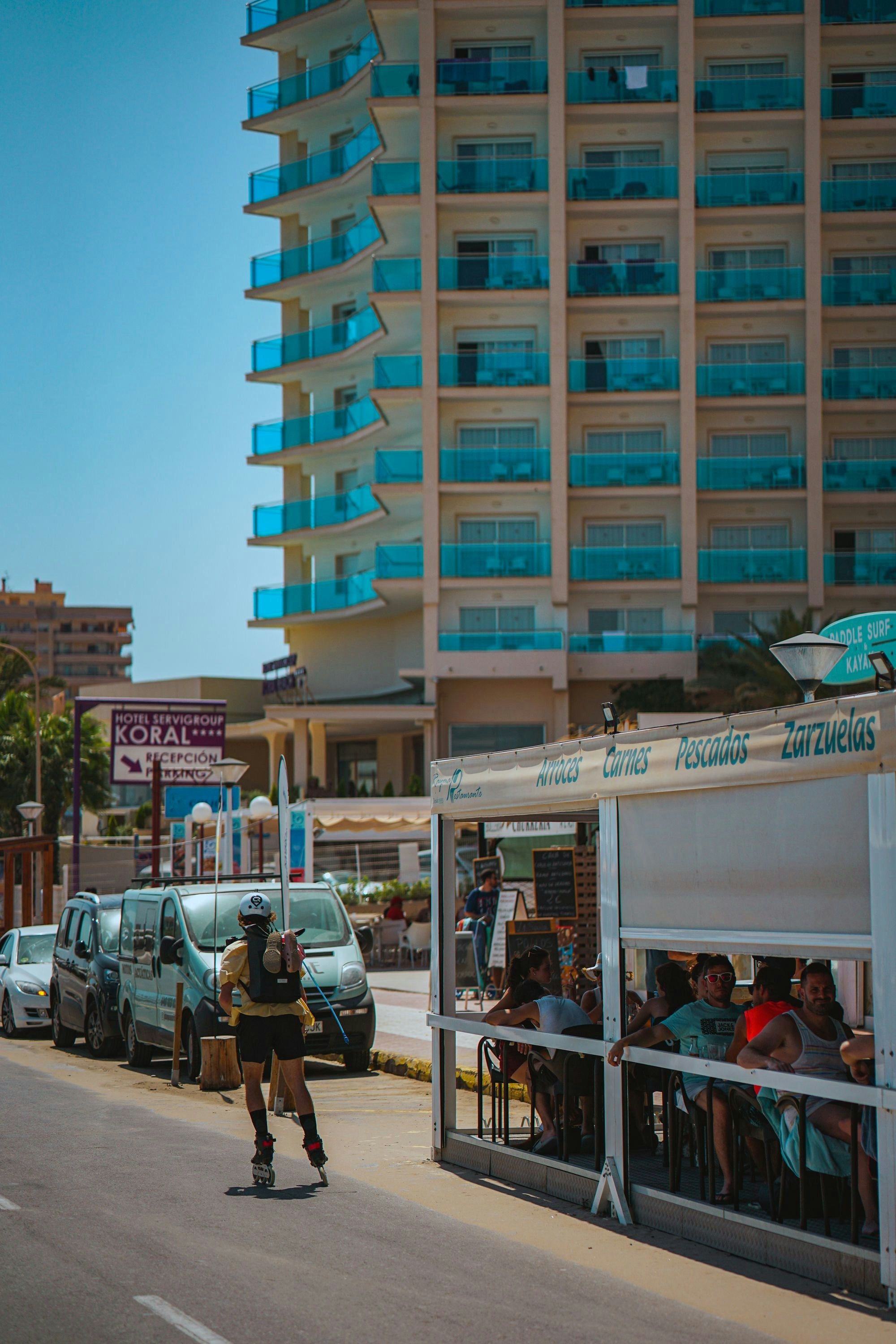 a man riding a skateboard down a street next to a tall building