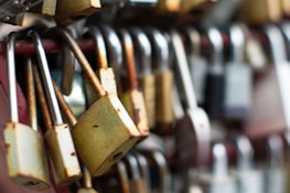 a bunch of padlocks hanging on a wall