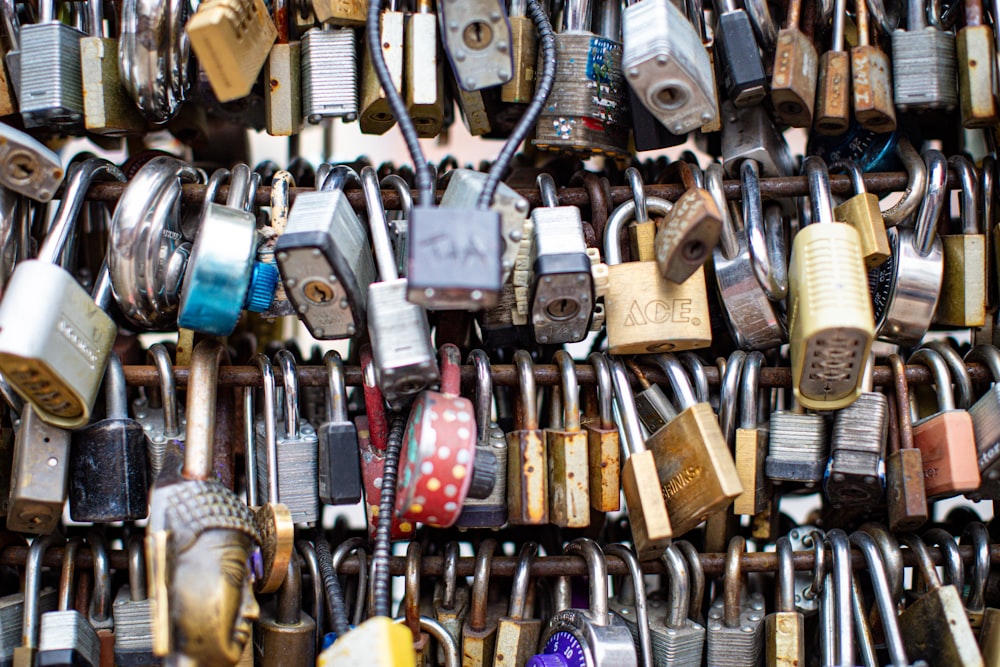 a bunch of padlocks that are attached to a wall