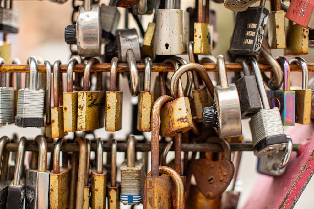 a bunch of padlocks are hanging on a wall