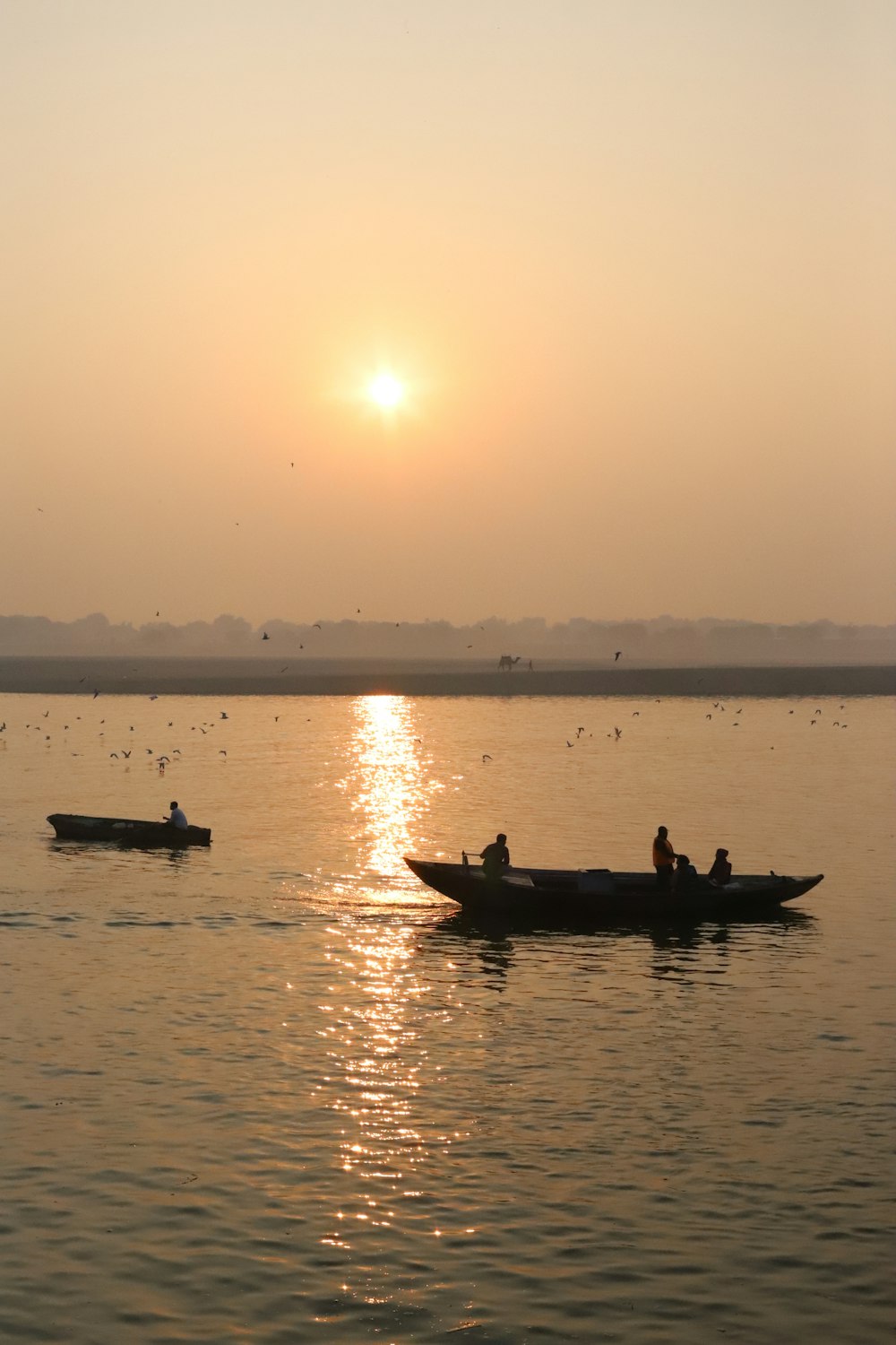 a couple of boats floating on top of a lake