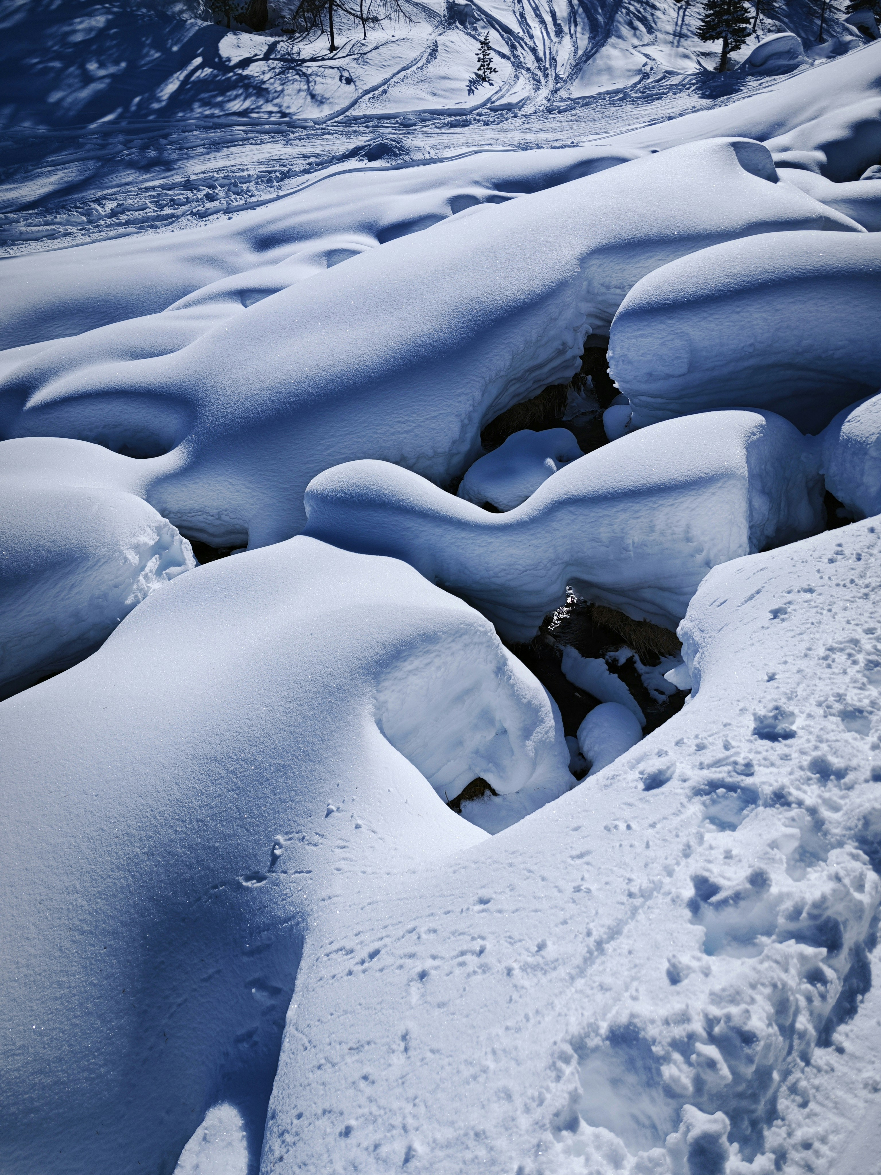 a snow covered mountain with a stream running through it