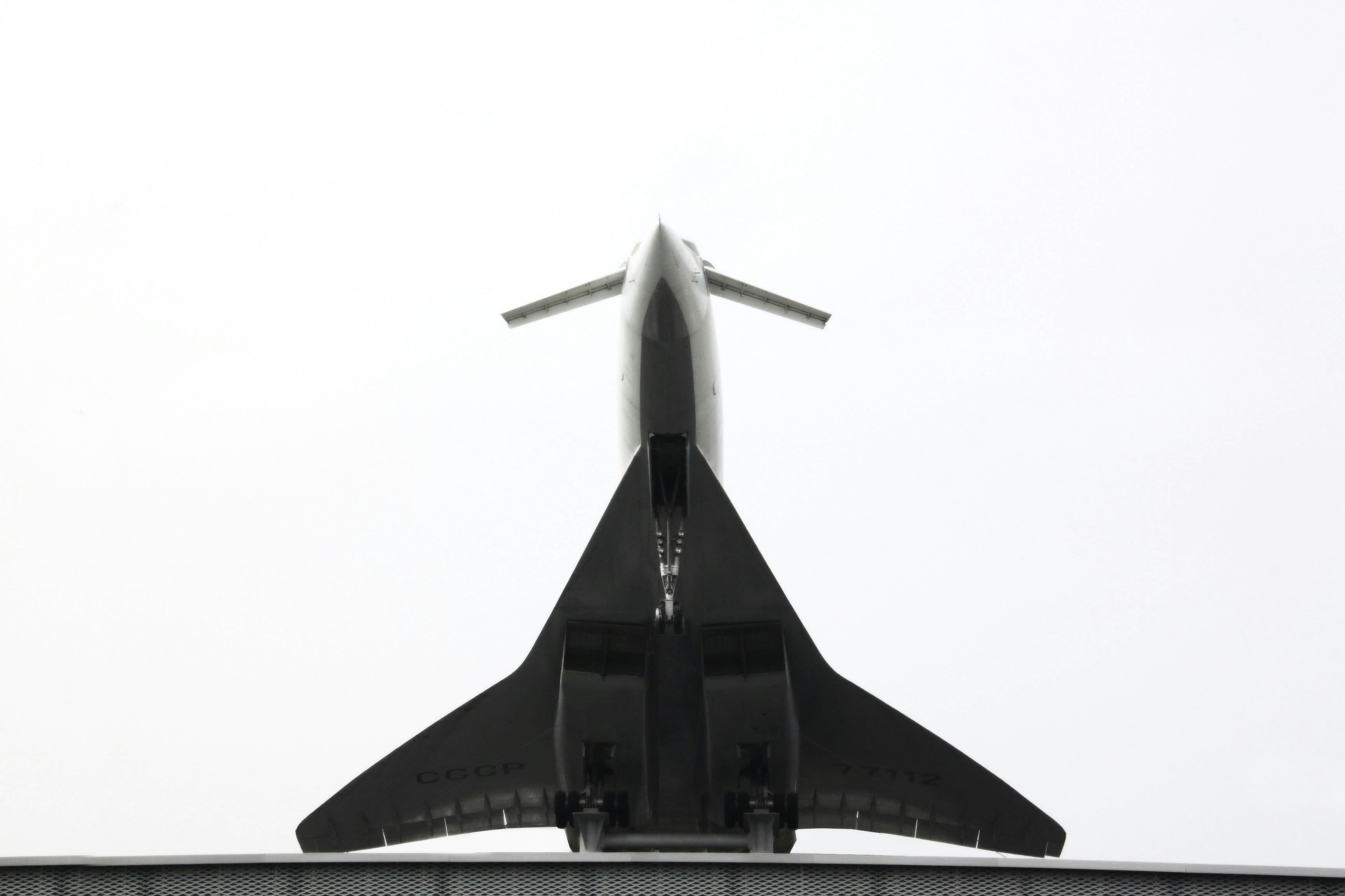 a large jetliner flying through a cloudy sky, 