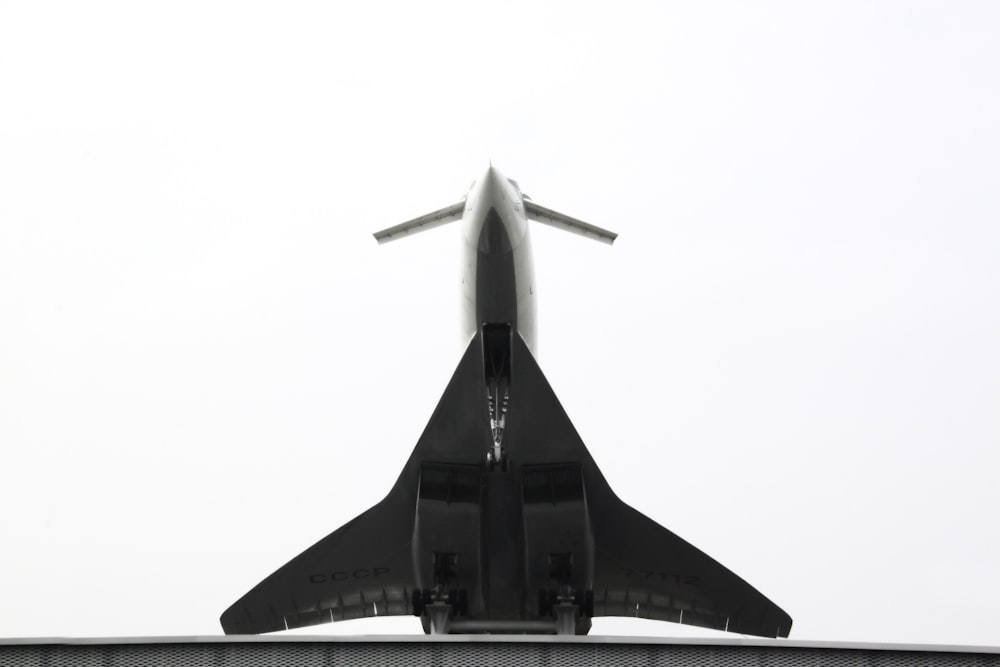 a large jetliner flying through a cloudy sky