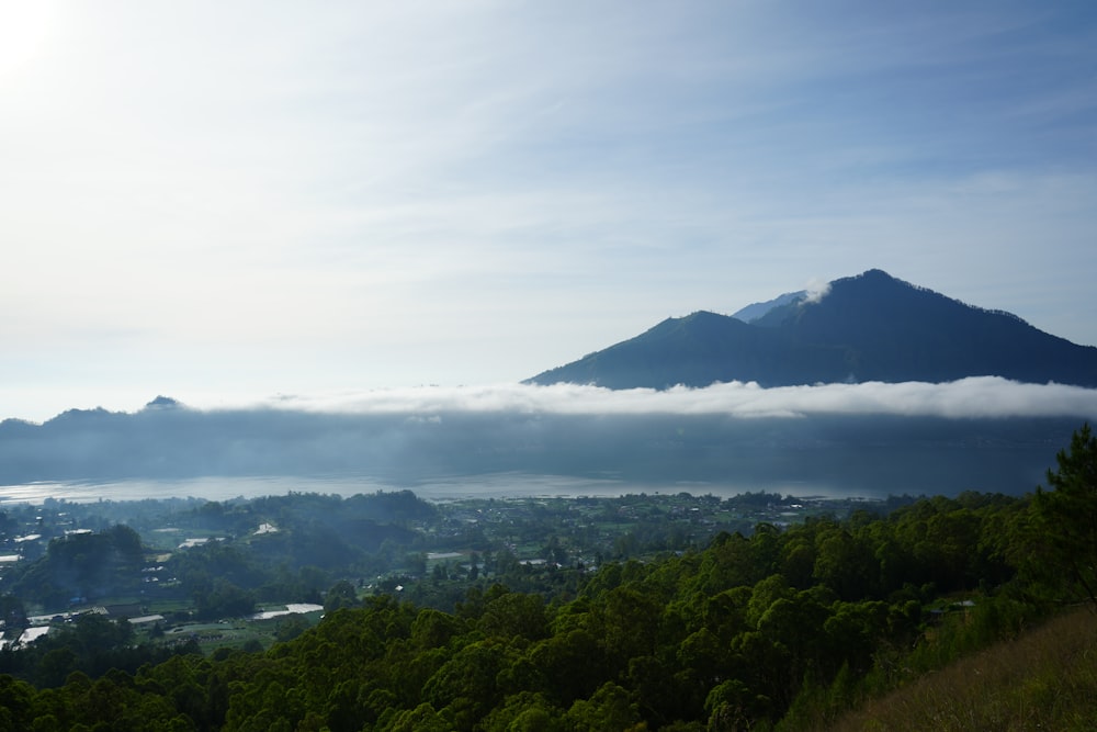 a view of a mountain with low lying clouds