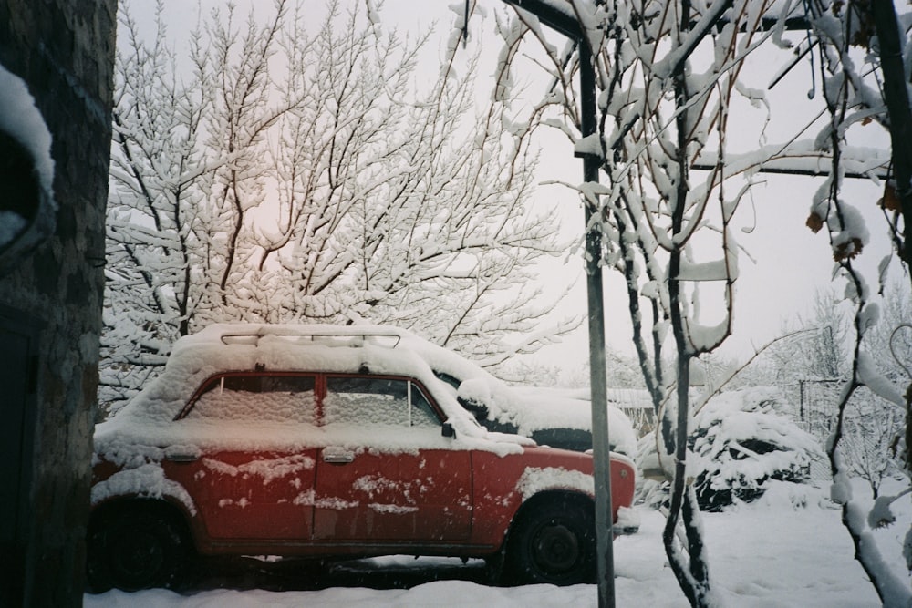 a red truck is parked in the snow