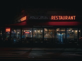a restaurant that is lit up at night