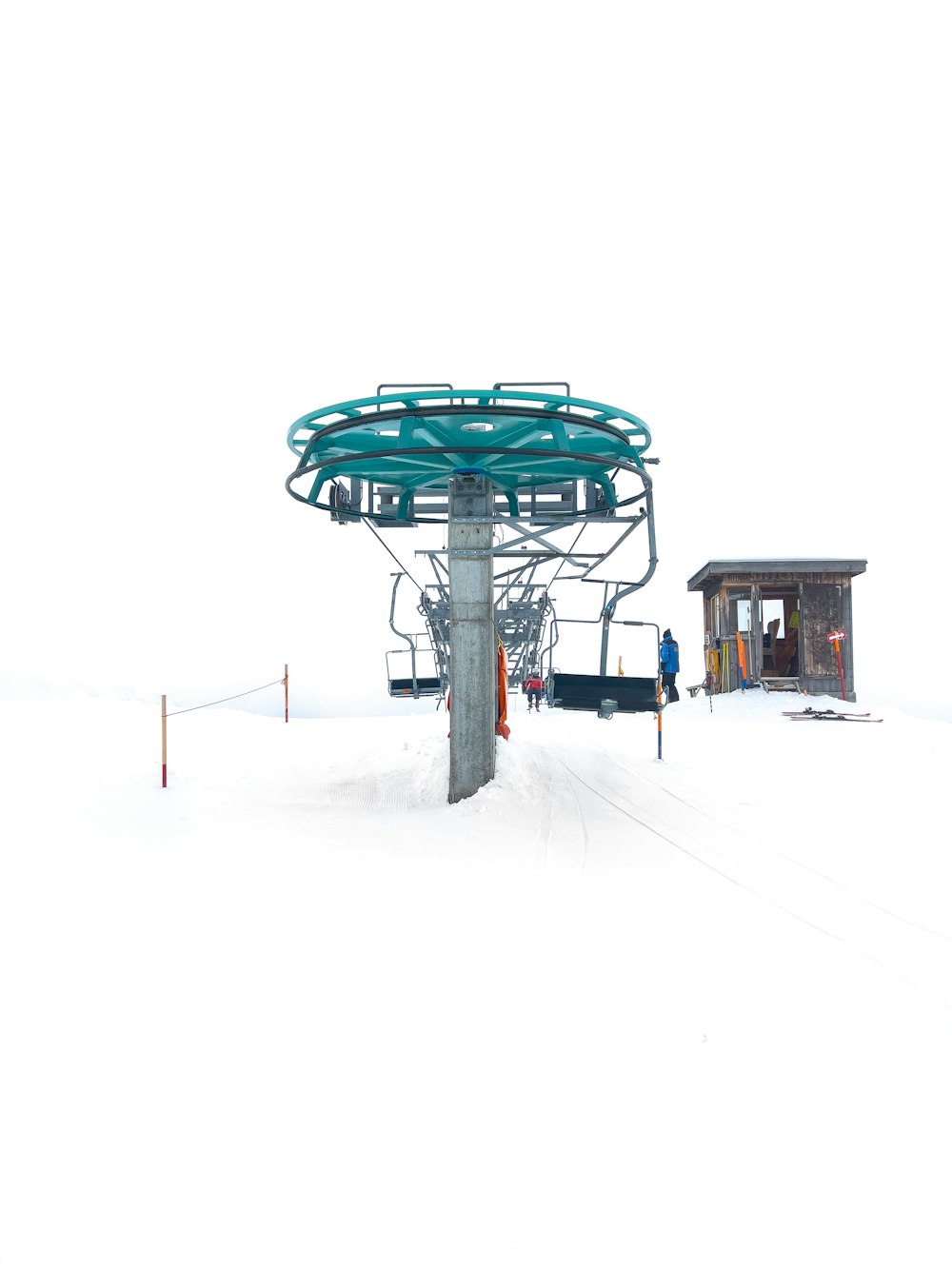 a ski lift sitting on top of a snow covered slope