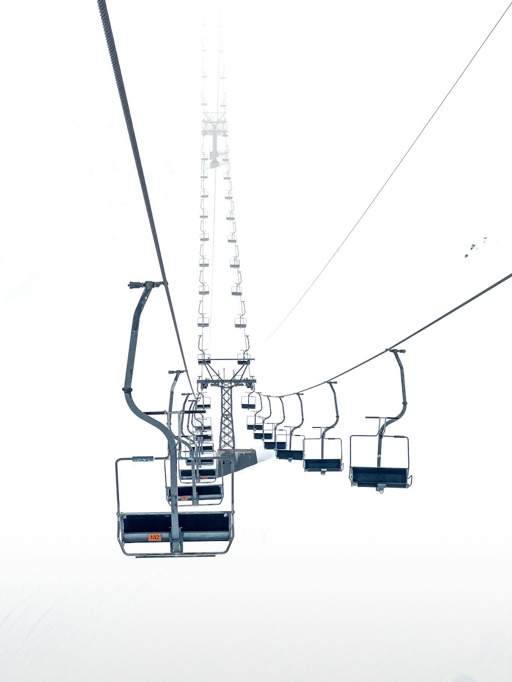 a ski lift going up a snowy mountain