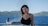 a woman standing on a boat looking at the camera