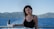 a woman standing on a boat looking at the camera