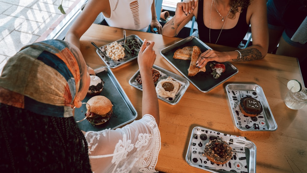 a group of people sitting around a table eating food