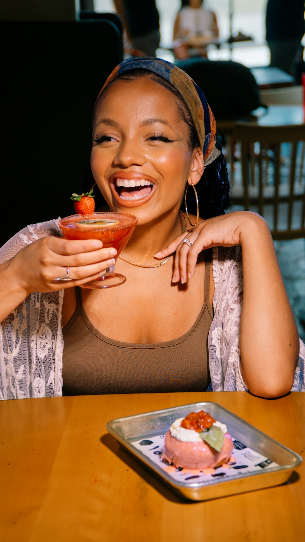 a woman sitting at a table with a plate of food