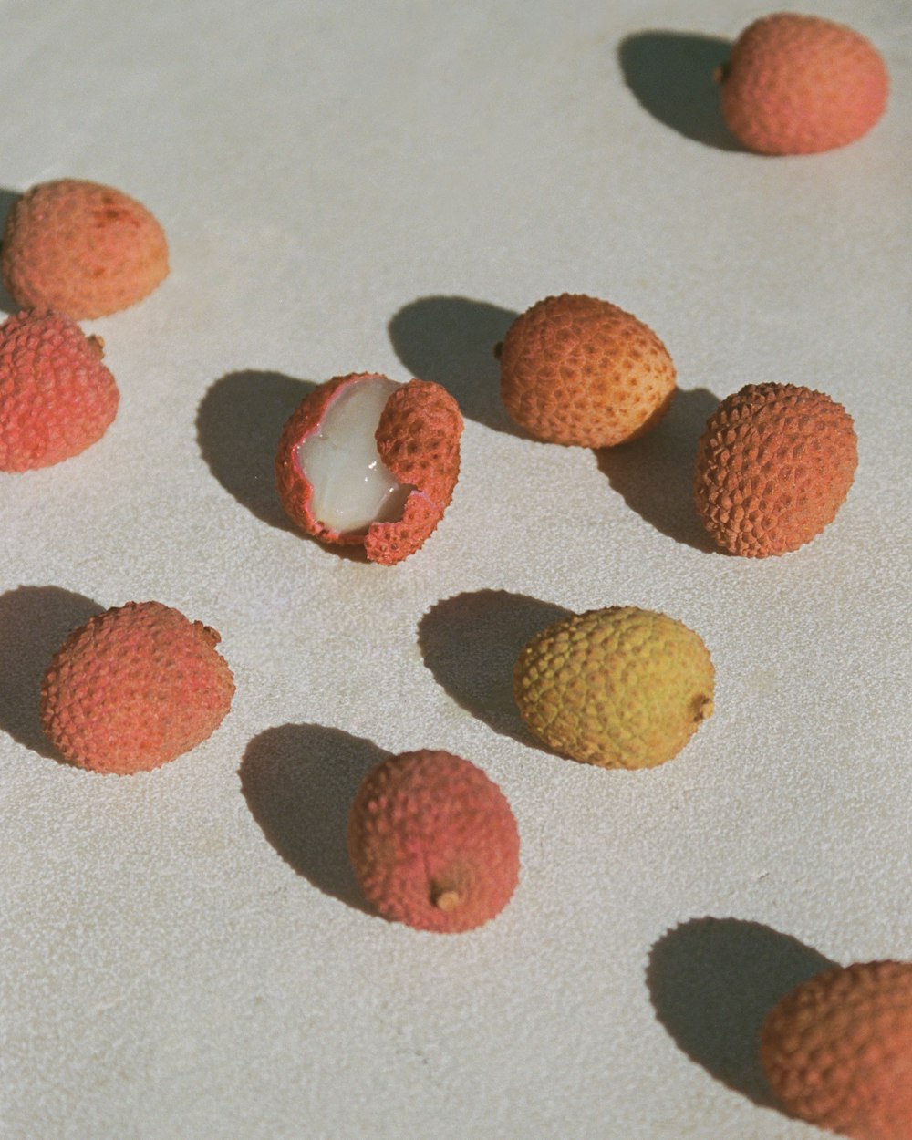 a group of fruit sitting on top of a white surface
