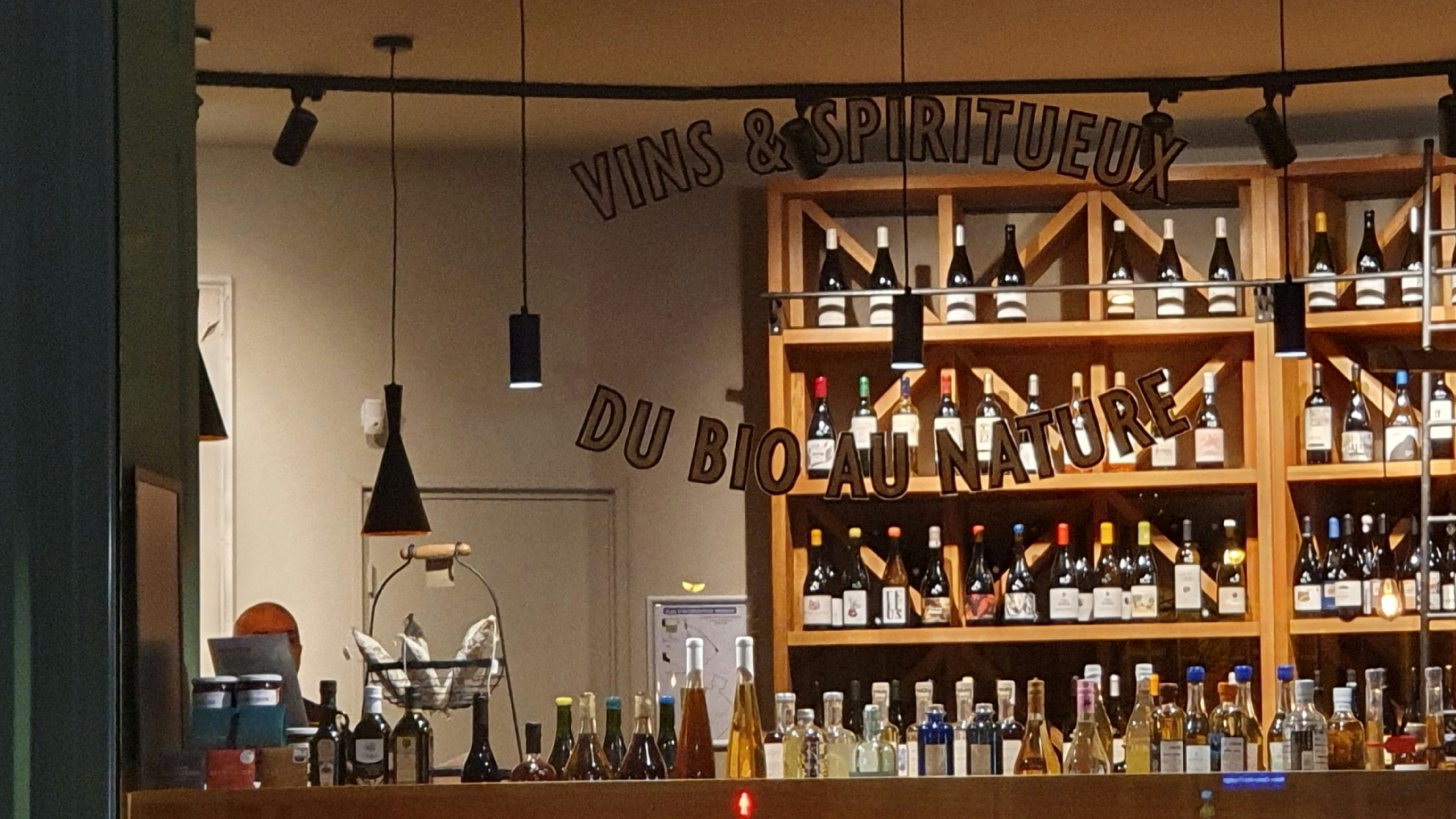 Rows of wine and spirits bottles in a well-lit liquor store