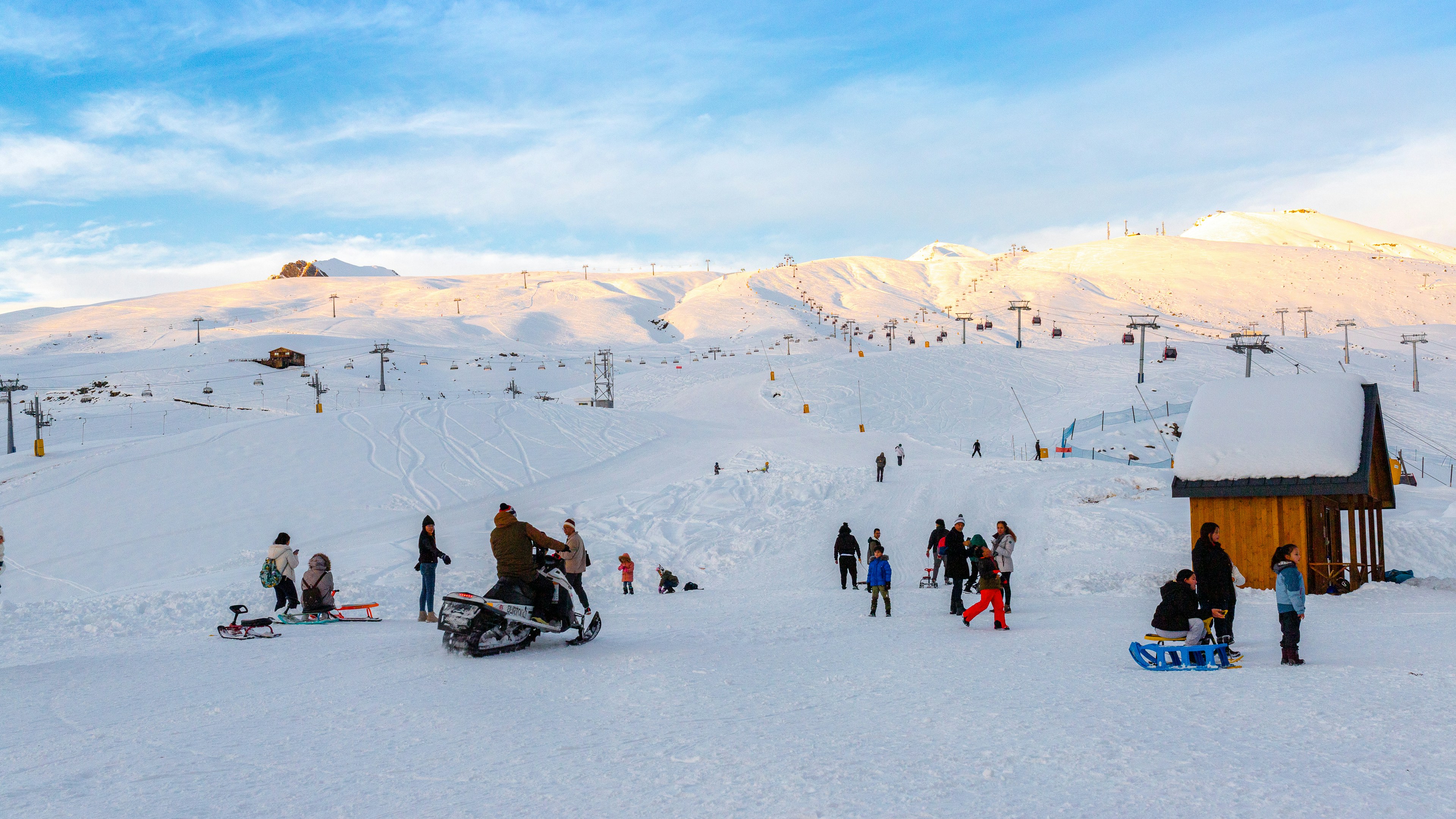 a group of people standing on top of a snow covered slope