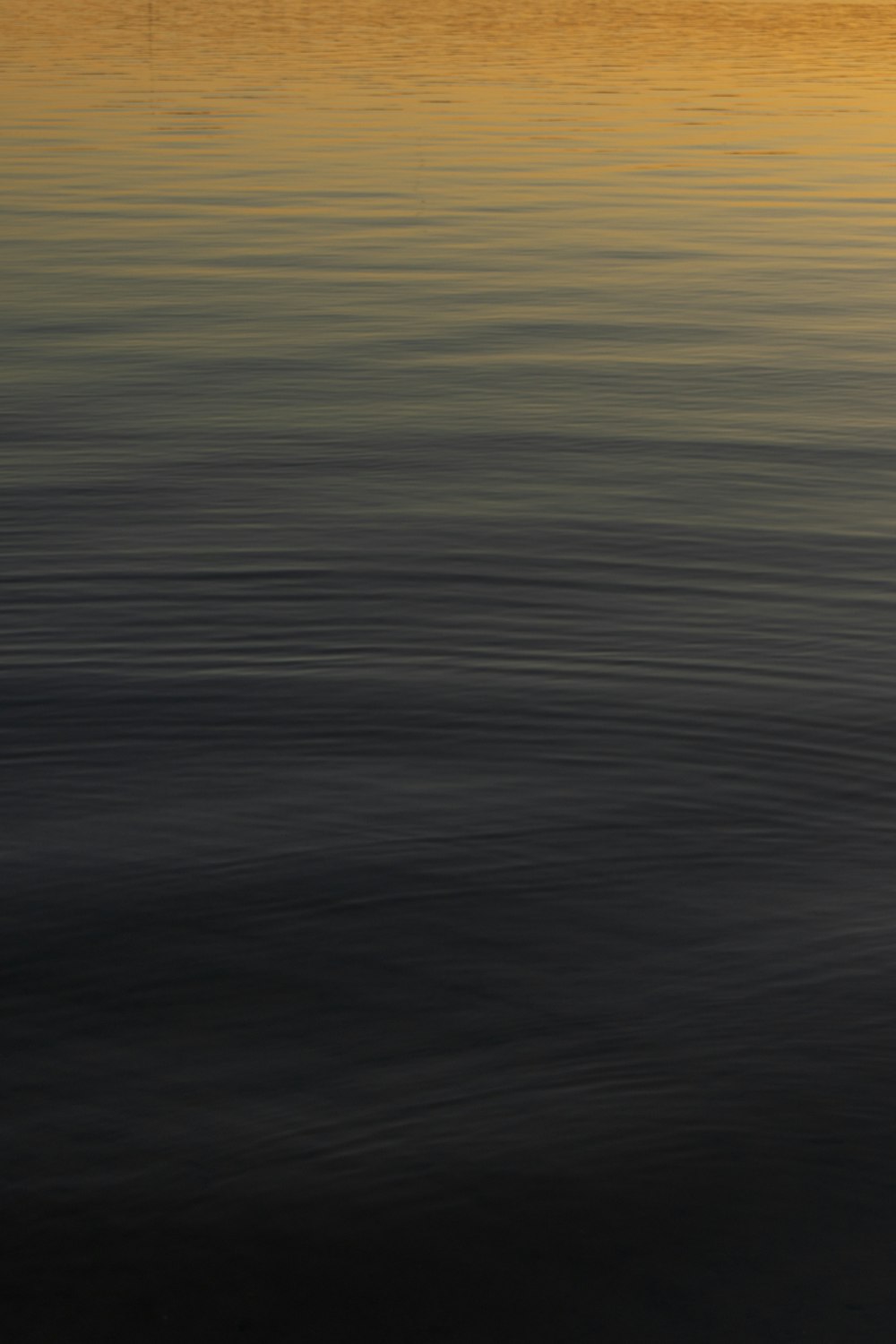 a boat floating on top of a large body of water