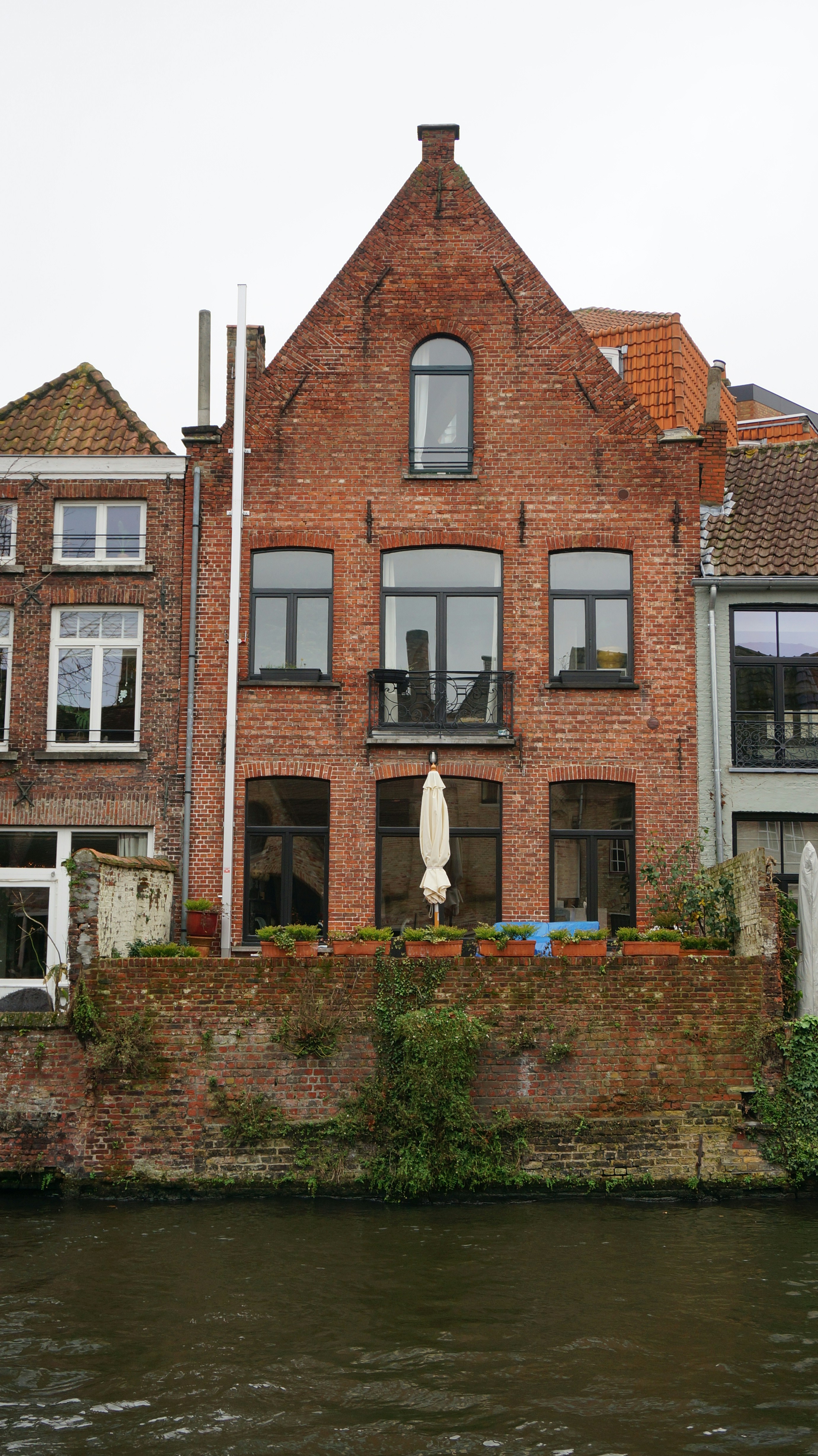 a large brick building sitting on the side of a river