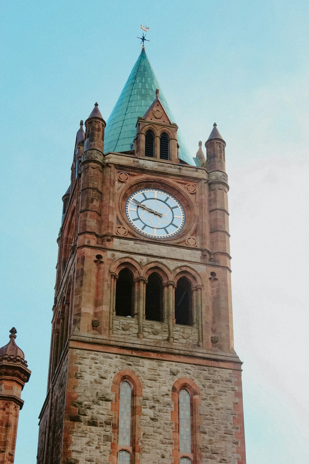 a large clock tower with a sky background