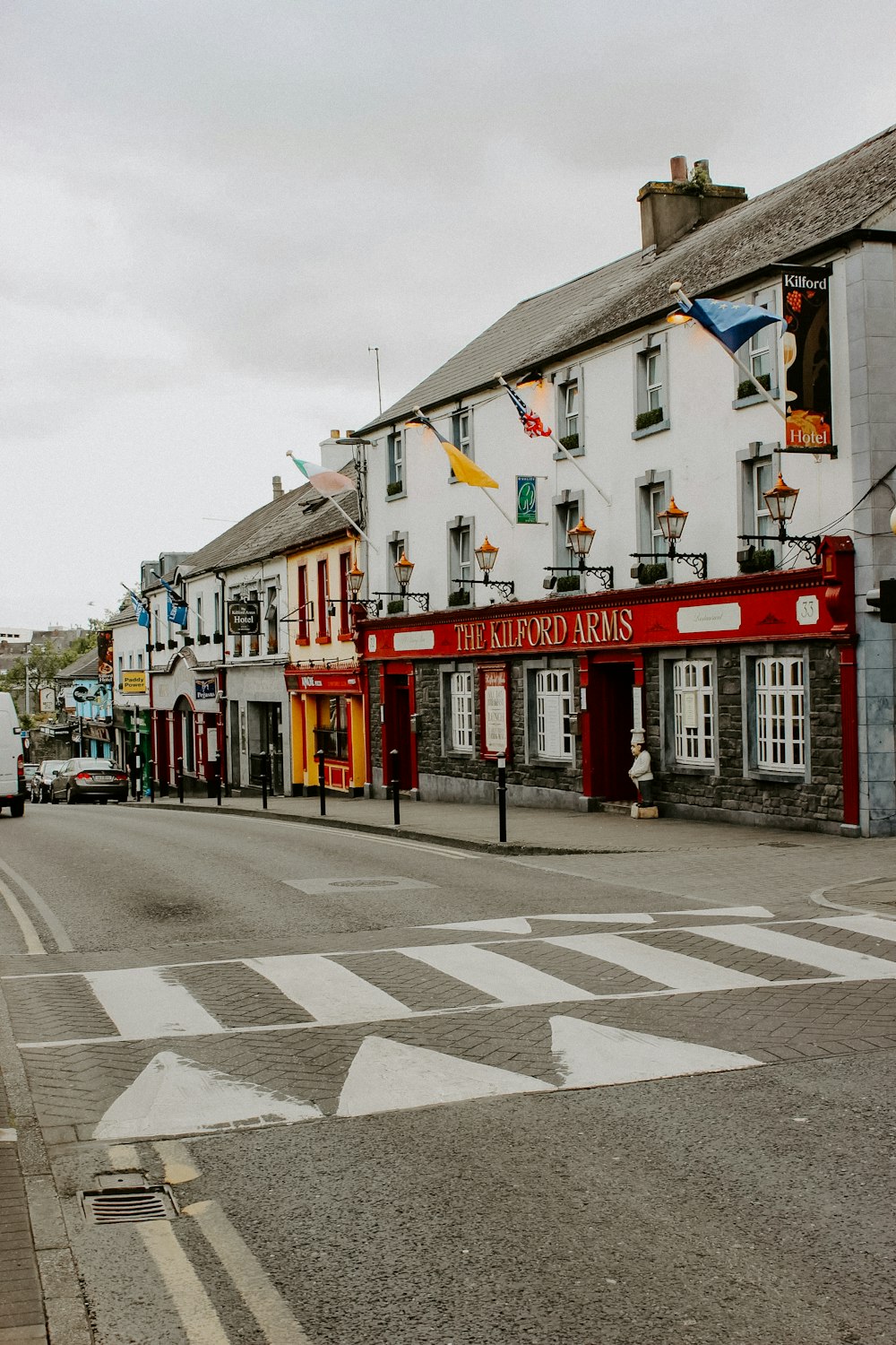 a city street with buildings and a crosswalk