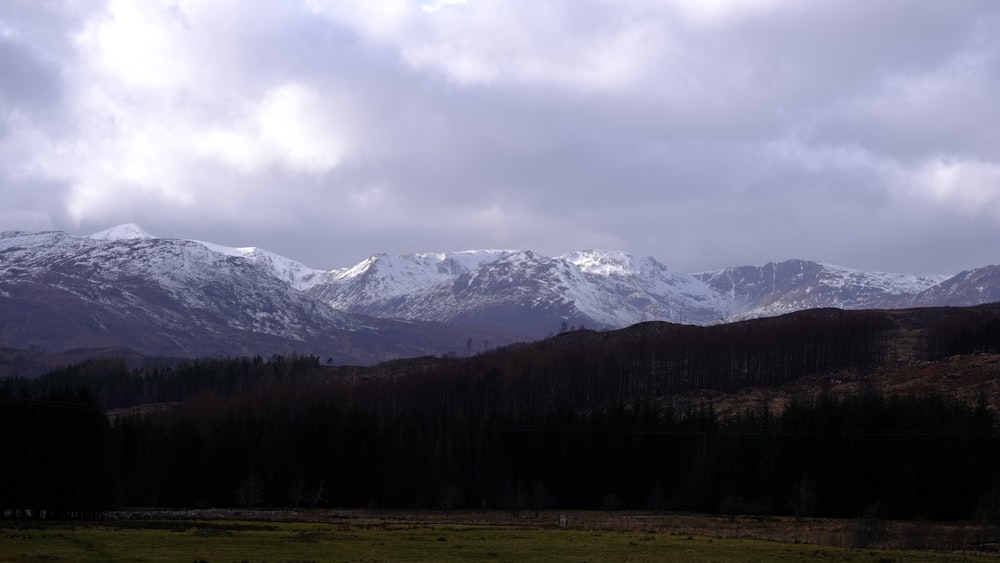 the mountains are covered with snow in the distance