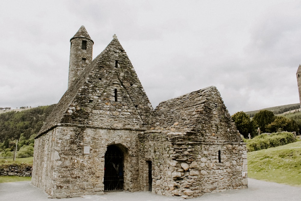 an old stone building with two towers on top of it