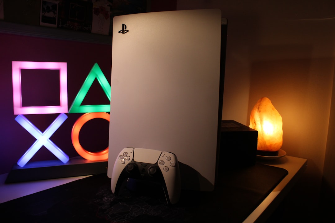 a video game console next to a neon sign, PlayStation 5 in warm light and a lamp representing playstation button icons on the side