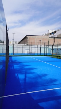 a tennis court with a blue surface and white lines