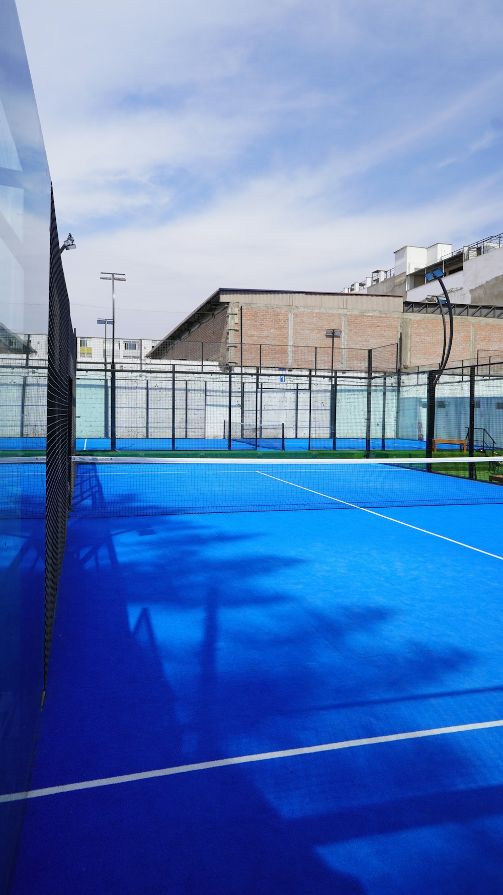 a tennis court with a blue surface and white lines