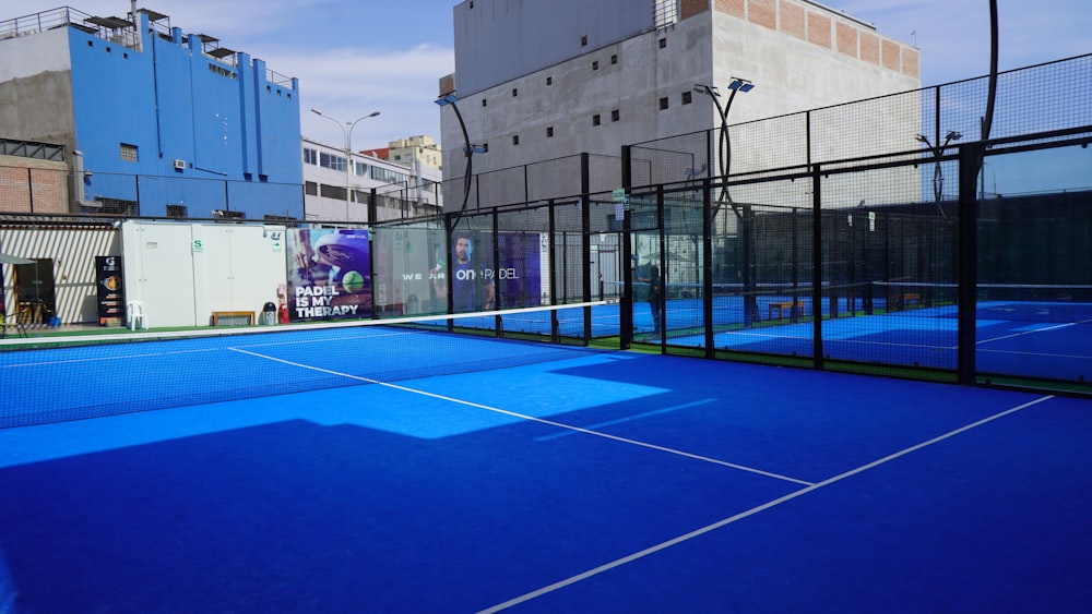 a tennis court with a blue tennis court cover