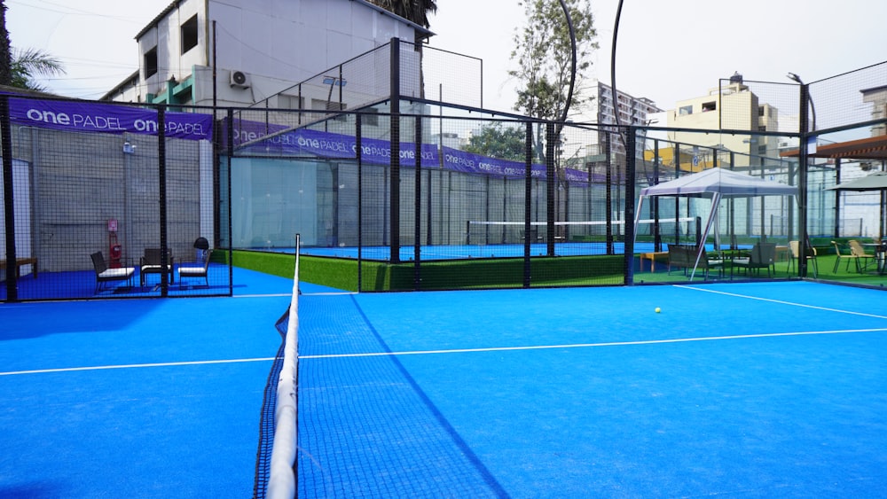 a tennis court with a net and chairs