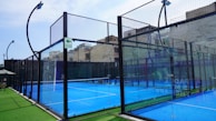 a tennis court with a fence surrounding it