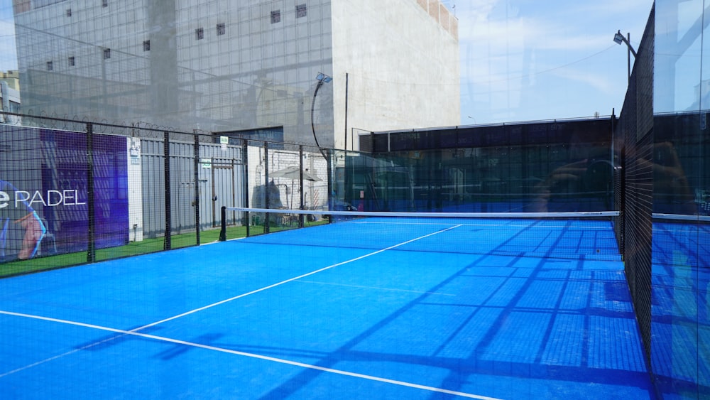 a tennis court with a blue tarp on it